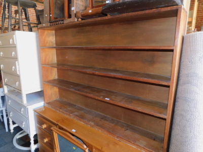 A long and narrow pine bookcase, enclosing three fixed shelves, 101cm high, 155cm wide, 24cm deep.