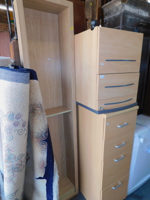 An oak effect bookcase, together with a beech effect chest of four drawers, and a beech effect filing cabinet, 128cm high, 112cm wide. (3)