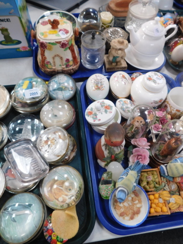 Glass paperweights, to include dolphin paperweight, 9cm diameter, Wedgwood Kutani Crane lidded jar, ceramic egg ornaments, Wade biscuit barrel, Royal Commemorative cups, small quantity of glassware, etc., (3 trays).