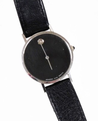 A Movado wristwatch, with circular watch face with blackened dial with tiny diamond set twelve point bezel, in a white metal case stamped 14k, on a black leather strap, the dial 3cm diameter.