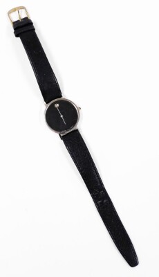 A Movado wristwatch, with circular watch face with blackened dial with tiny diamond set twelve point bezel, in a white metal case stamped 14k, on a black leather strap, the dial 3cm diameter. - 3