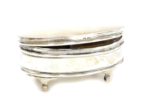 A George V silver ring box, with plain lid, fitted interior on quadruple scroll feet, Birmingham 1925, 9cm wide, 3.2oz all in.