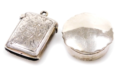 A late Victorian miniature vesta case, engraved with scrolls and flowers, with silver gilt interior and match strike base, with fixed ring top, Birmingham 1899, 4cm, and a silver pill box, 0.7oz all in. (2)