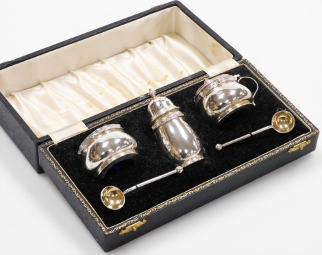 A five piece cased condiment set, principally Elizabeth II comprising pepper pot 8cm high, mustard pot and open salt, and two Victorian rat tail spoons in fitted case, 4.4oz of silver.