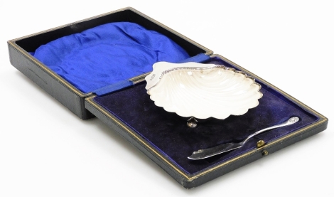 A George V silver and glass shell shaped butter dish and knife, with removable liner on orb feet with butter knife in fitted case, Sheffield 1919, 2.2oz of silver.