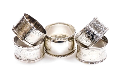 Five various silver napkin rings, to include a Victorian napkin ring of shaped circular form, heavily decorated with scrolls, initial cartouche, Birmingham 1887, and four others, 4oz all in. (5)