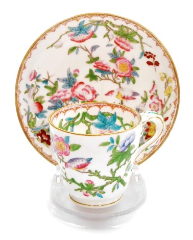 A Minton cup and saucer, profusely decorated with flowers birds and vines, marked English porcelain Minton 3934, the cup 6cm high, the saucer 12cm diameter.