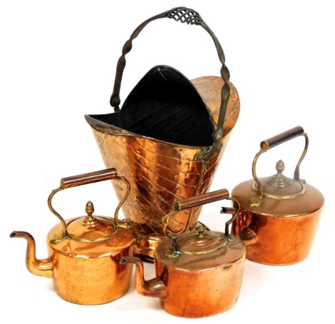 Early 20thC and later copper, to include three copper kettles, and a helmet shaped coal bucket, of flared design. (4)