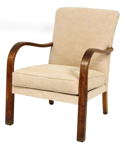 A 20thC oak framed armchair, with overstuffed back and seat, in raised floral material, with loose cushion, front block shaped stiles, 90cm high.