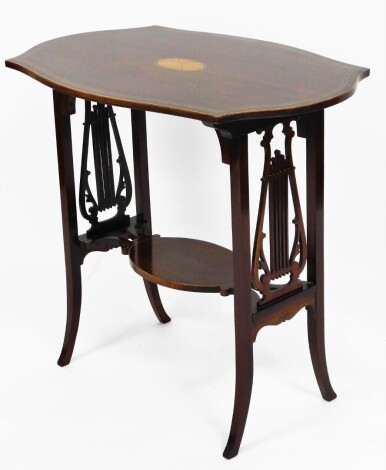 An Edwardian side table, the flared shaped top with parquetry shell inlay on lyre end supports with lower tier shelf on splay feet, 71cm high, 77cm wide, 50cm deep.