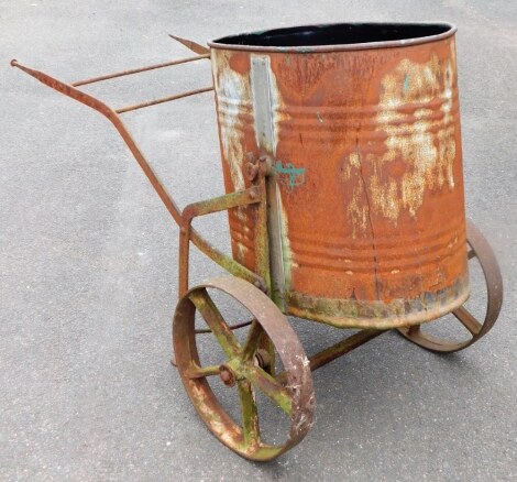 A vintage galvanised water butt, on a wheel barrow type metal frame, 87cm high, 132cm wide.