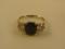 A three stone set ring with a central oval sapphire of 9mm x 7mm approx