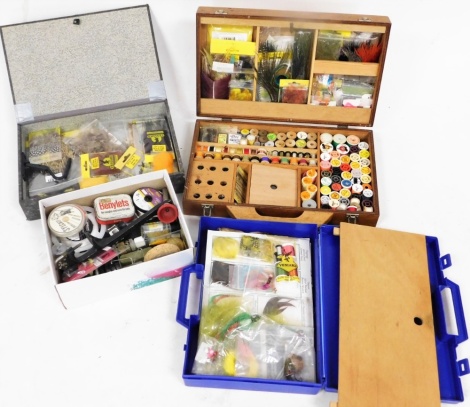 A collection of fly tying materials and equipment, including tying vice, a case of threads and capes, etc.