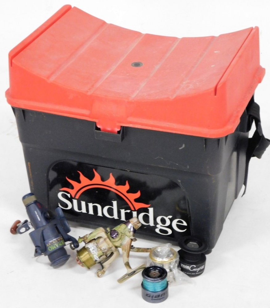 A Sundridge fishing tackle box seat, two fixed spool reels and spools.