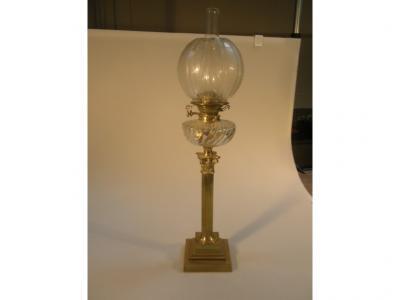 A Victorian brass Corinthian columnar oil lamp with wrythen clear glass