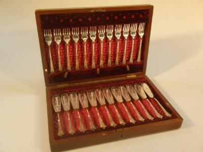 A mahogany canteen of twelve pairs of electroplate decorative fish cutlery