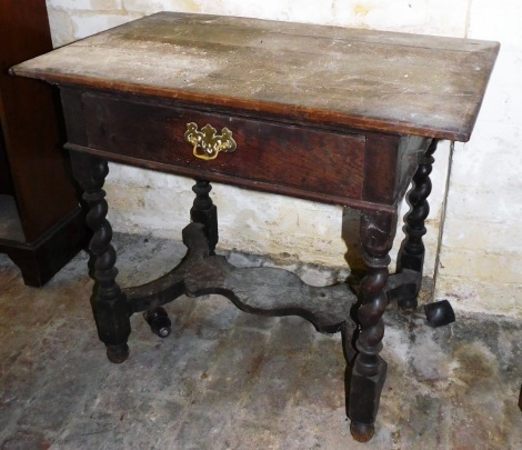 A 17thC oak side table, with overhanging top, frieze drawer and barley twist legs, with a platform support, 73cm high, 86cm wide, 53cm deep.