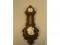 An Edwardian carved oak nautical aneroid wheel barometer with clock over