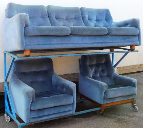 A 1970s/80s retro blue draylon sofa suite, comprising three seater sofa and two armchairs, teak turned legs, the sofa 70cm high, 222cm wide, 76cm deep.