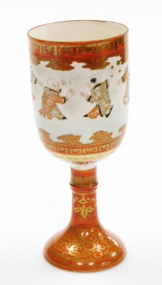 A late 19thC Japanese Kutani goblet, decorated with seated and dancing figures, in Kutani patterning on a cylindrical stem and trumpet base, bears three signatures to underside, 19cm high. - 2