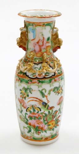 A Chinese Canton rose medallion porcelain baluster vase, the top flared rim with gilt dog of fo handles, and applied dragon decoration, painted with figures, birds and flowers, 19thC, 20cm high.