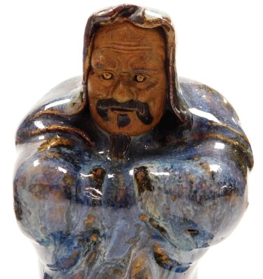 Three Chinese glazed pottery "mudmen" Immortals, each with glazed colouring, including a sage with purple robes, 34cm high, a bearded figure holding a shoe in red and green robes, 32cm high, and another sage robed in blue, hardwood bases, 13cm high. (3) - 8