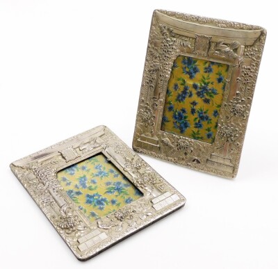 A pair of Japanese antimony photo frames, each with embossed decoration of a gateway (torri) surrounded by birds, chrysanthemums and wisteria, Meiji period, 25cm x 18.5cm.