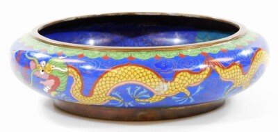 An early 20thC Chinese cloisonne bowl, of circular form, decorated with front facing dragon in yellow, green and red on a blue ground, the reverse with four character Ming mark, 26cm diameter. - 2