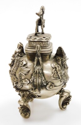 A Chinese polished metal censer, with dragons in high relief and phoenix handles, on three feet formed as waves, the cover with klylin knop, four character Qianlong mark beneath, probably 20thC, 25cm high. - 4