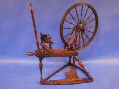 A 19thC elm and fruit wood spinning wheel