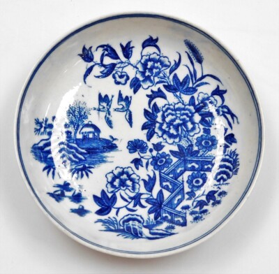 A first period Worcester porcelain circular dish, in blue and white decorated with zig-zag Fence pattern, birds and buildings, crescent mark, 11cm diameter.