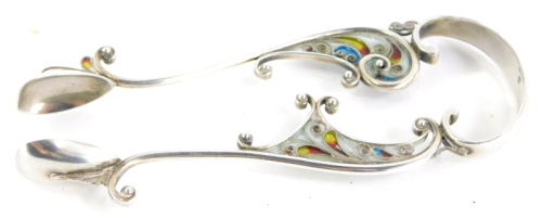 A pair of Marius Hammer silver and plique a jour enamel sugar tongs, decorated with a design of scrolls, etc., in turquoise, yellow, red and silver, stamped 930S and with monogram mark.