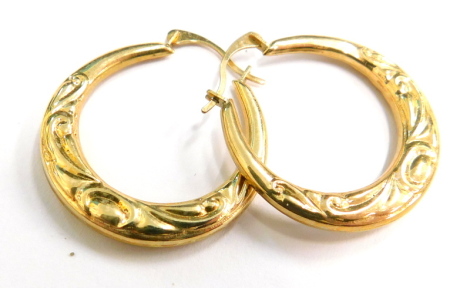 A pair of 9ct gold hoop earrings, each with an embossed decoration, in Elizabeth Duke box, 1.2g all in.