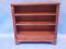 A Regency mahogany open bookcase with reeded decoration single drawer with