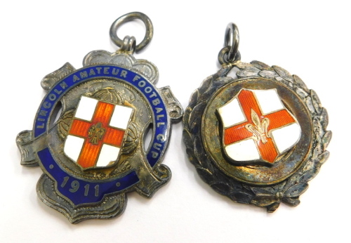 Two silver sporting medallions, to include The Lincoln Amateur Football Club 1911, with enamel decoration, and another Lincoln shield, 27.7g. (2)