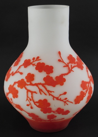 An acid etched art glass vase, decorated with red flowering prunus on a white ground, in the manner of Gallé, 41cm high.