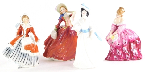 Four Royal Doulton porcelain figurines, Autumn Breezes, Margaret, Victoria and Noelle.