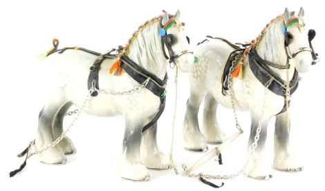 Two Beswick grey Shire horses, each with tack.