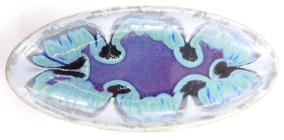 An art pottery boat shaped dish, with mottled decoration in blue, turquoise, purple, white, etc., unmarked, 67cm long.