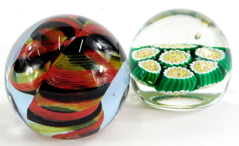 Two art glass paperweights, to include a Caithness paperweight The Sorcerer, and a Millefiori green and yellow paperweight. (2)