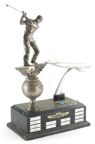 The Pan American Golf Trophy, with ebonised base mounted with a silver plated golfer and an aeroplane, recipients dated from 1959-1970, 53cm high, and three Pan American airlines pin badges.