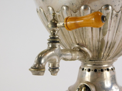 A late 19th/early 20thC silver plated two handled samovar, engraved with scrolls, surrounding a vacant cartouche, with part fluted body, complete with burner section (wedged), on a square foot with bun feet, 59cm high. - 3