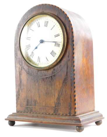 An Edwardian oak and chequer banded mantel clock, in a domed case with white enamel dial, on ball feet, 21cm high.