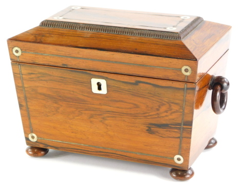 A Victorian rosewood pewter and mother of pearl inlaid sarcophagus shaped tea caddy, the hinged lid enclosing two lidded divisions, on bun feet, 22cm wide.