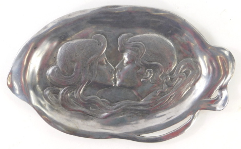 An Art Nouveau aluminium oval dish, with two figures about to kiss, 27cm.