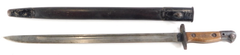 A First World War period bayonet, with mahogany handle and part leather scabbard, 58cm long.