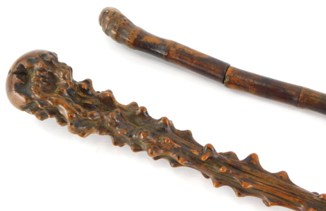 A late 19th/early 20thC bamboo sword stick, 78cm long, and a walking stick carved from a root, possibly blackthorn.