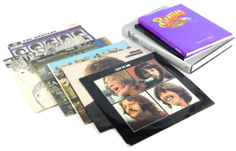 A collection of Beatles memorabilia, to include albums Let It Be, John Lennon collection, Sargent Peppers Lonely Hearts Club Band, Revolver, Hard Days Nights, a book titled Get Back, Beatles illustrated lyrics book, and The Beatles Have Anthology by The B