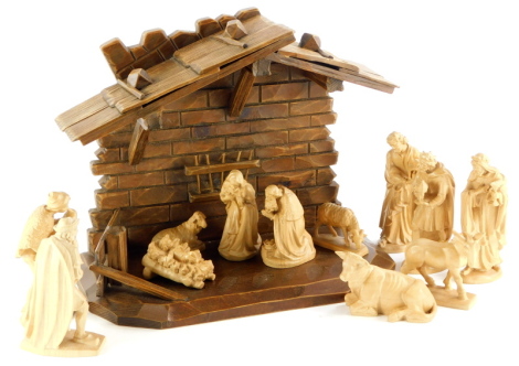 A Black Forest type carved wooden manger, and various carved wooden Nativity and other figures.