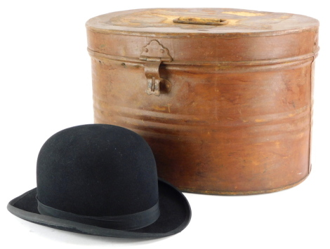 A late 19th/early 20thC brown painted tin oval hat box, and a bowler hat stamped New Model. (2)